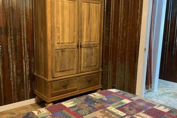 a bedroom with a wooden floor