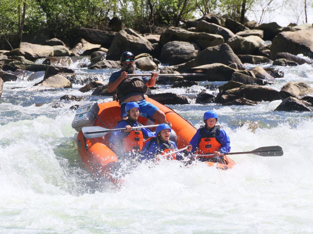 a man riding on a raft in a body of water