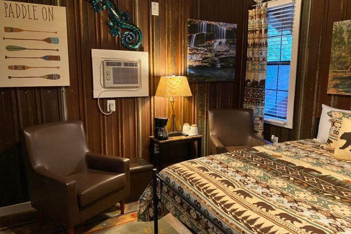 a bedroom with a bed and desk in a room