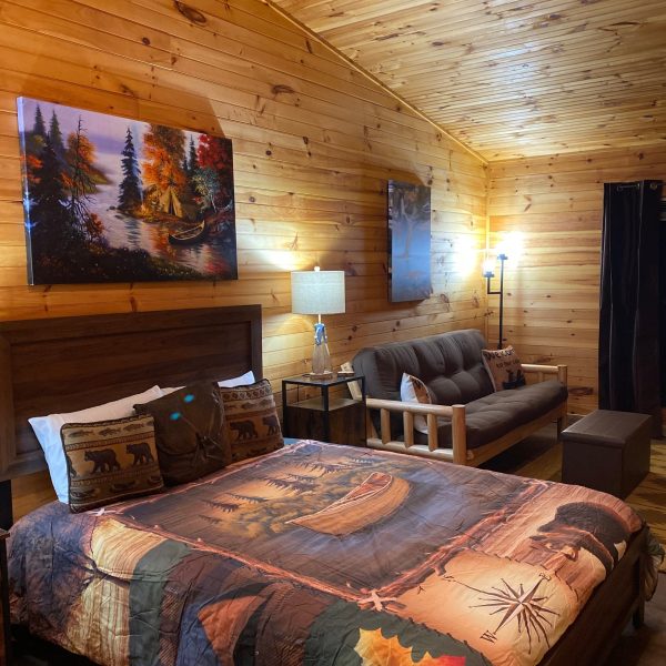 a bedroom with a bed and a chair in a room