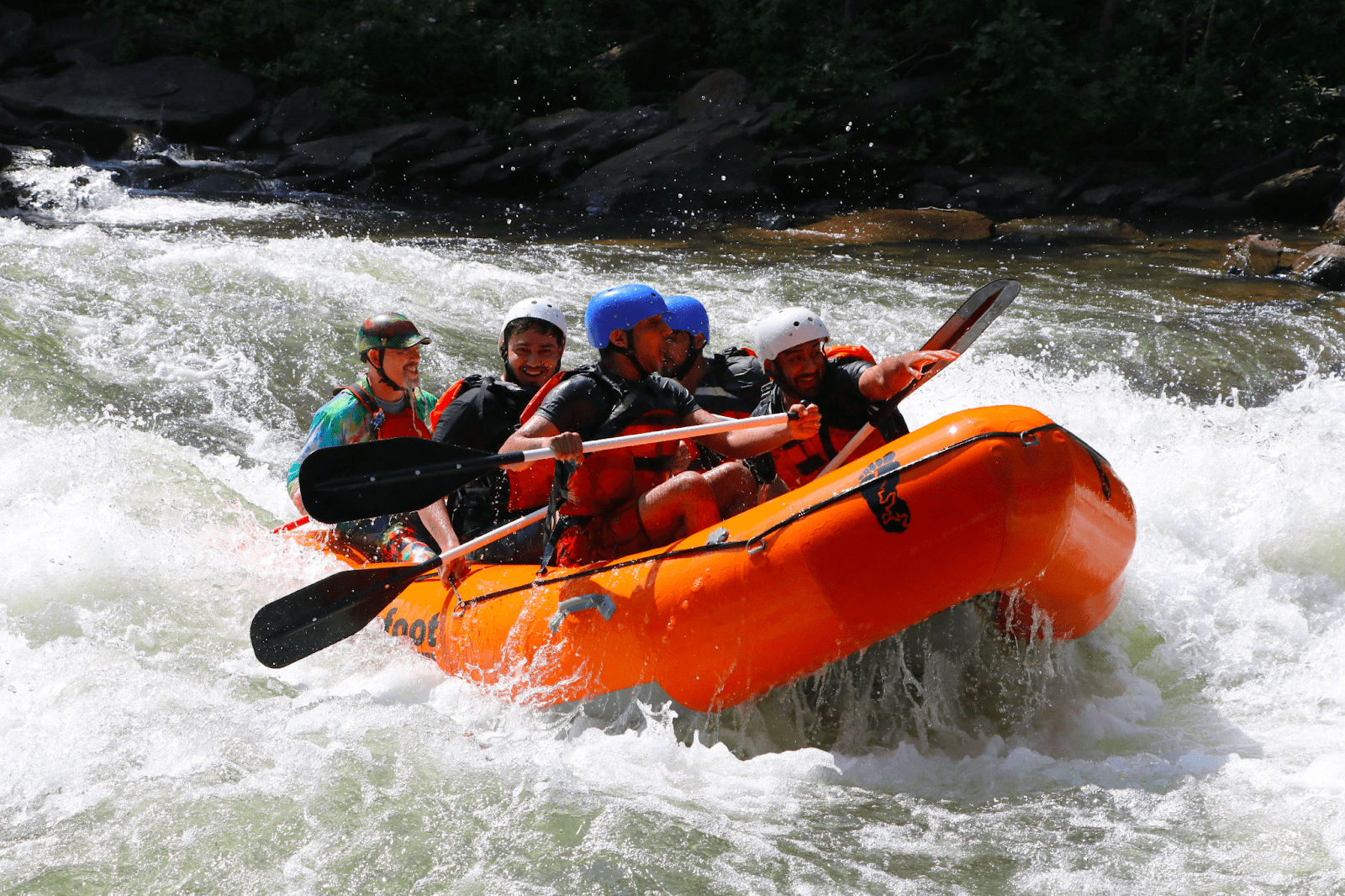 A Day in the Life of a River Rafting Enthusiast: Bigfoot Outfitters on the Ocoee River a man riding on a raft in a body of water