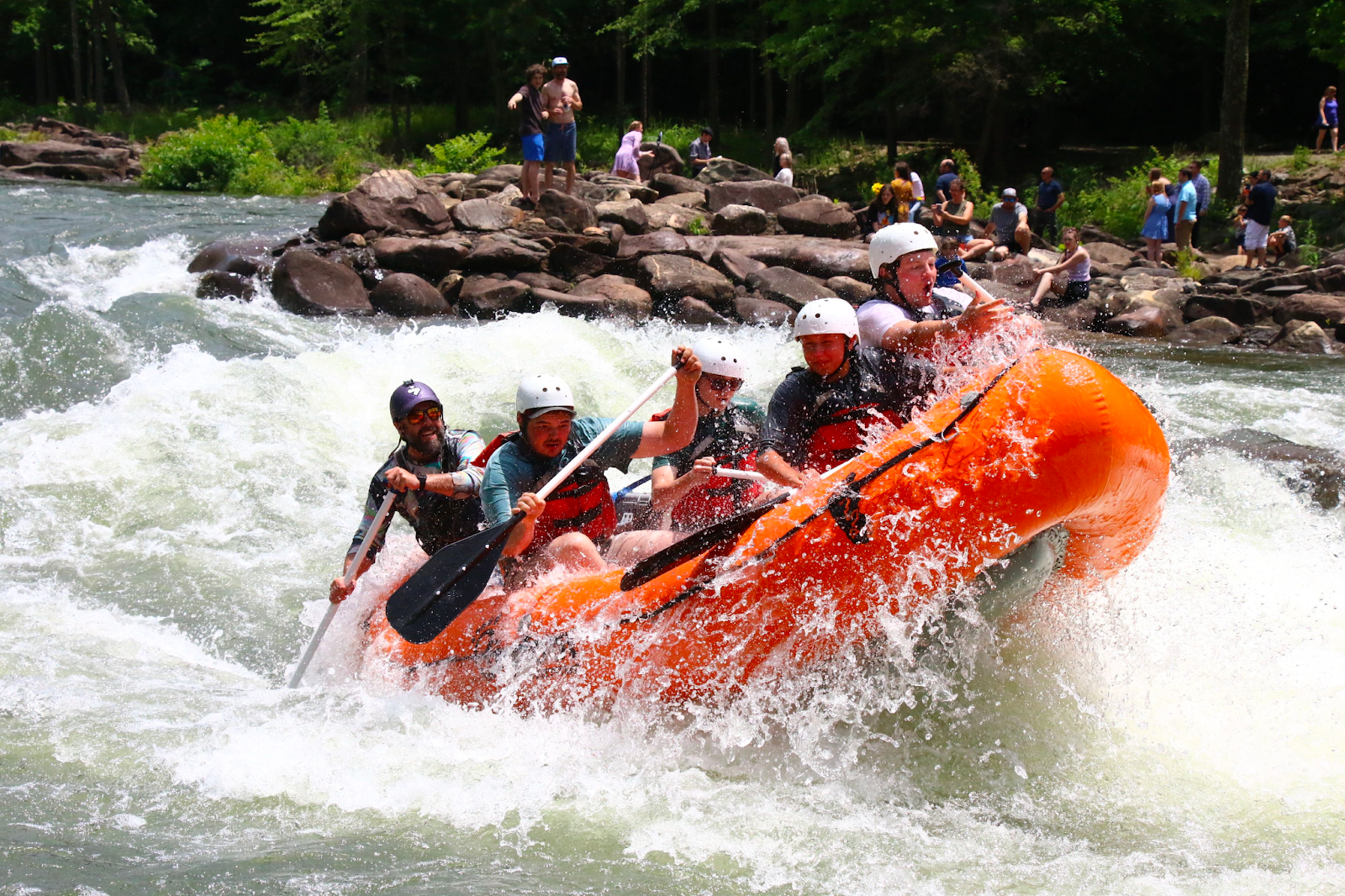 Top 3 Must-Try Rapids on the Ocoee River: A Bigfoot Outfitters Experience a man riding a wave on a surfboard in the water