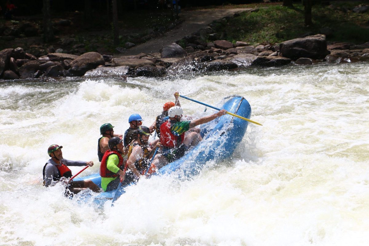 a group of people riding on a raft in a body of water