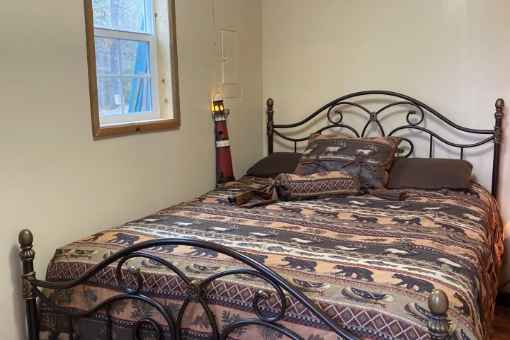 a bedroom with a bed and desk in a room