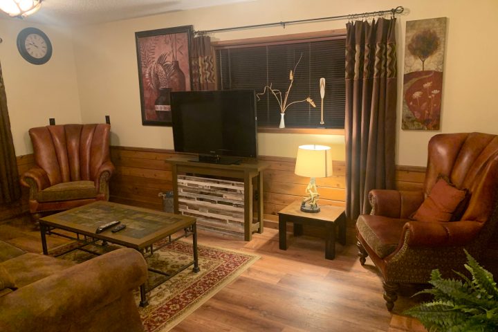 a living room filled with furniture and a large window