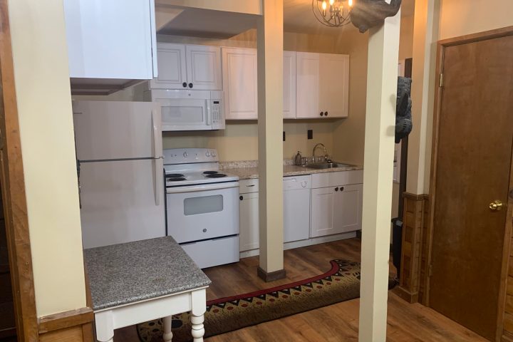 a kitchen with a sink and a mirror